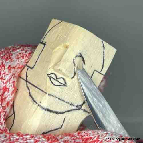 Carving up to eye socket on wood carved Buddha