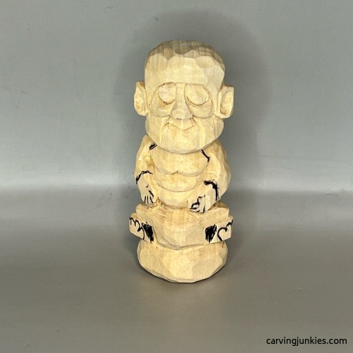 Front details on wood carved Buddha