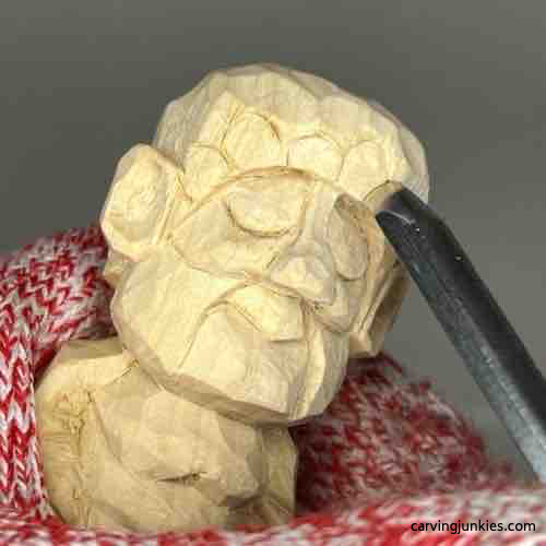 Carving hat on wood carved Buddha