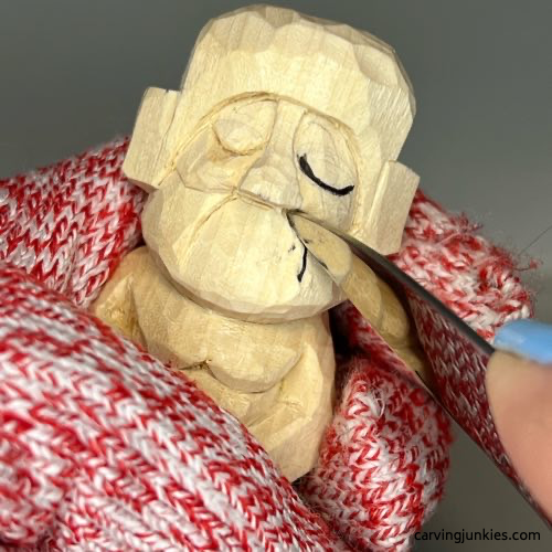 Separating the frown line on wood carved Buddha
