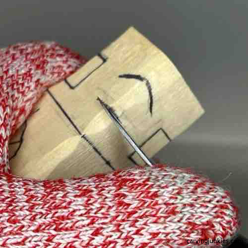 Cutting under the nose of wood carved Buddha