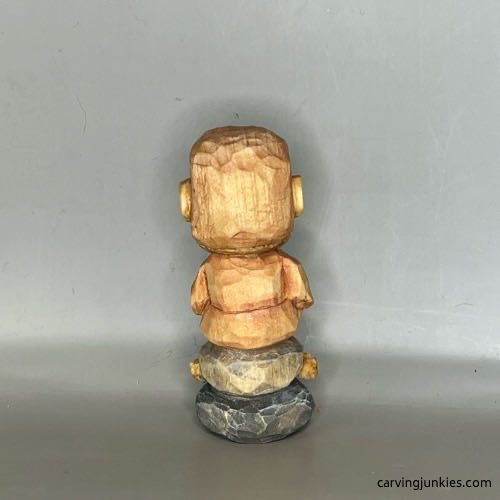 Back view of painted wood carved Buddha