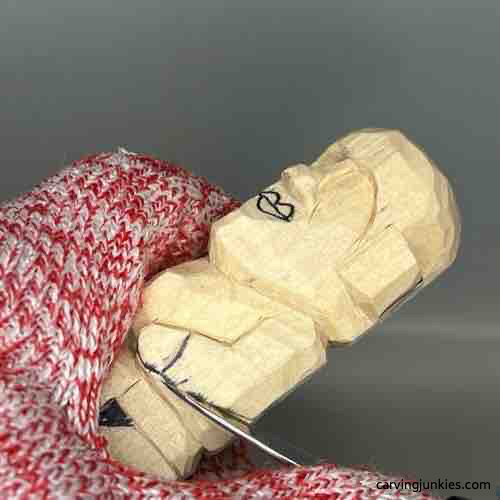 Using stop cut to separate arm on wood carved Buddha