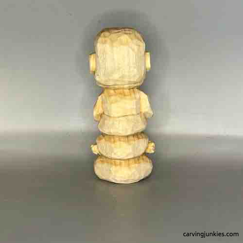 Back view of unpainted wood carved Buddha