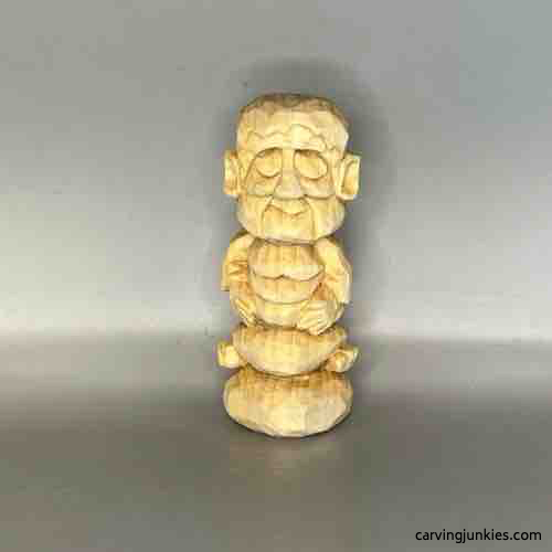 Front view of unpainted wood carved Buddha