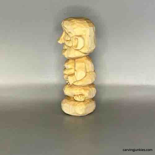 Left view of unpainted wood carved Buddha