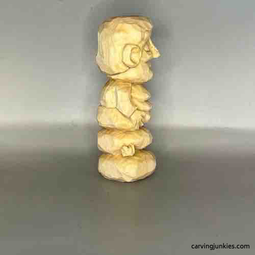 Right view of unpainted wood carved Buddha