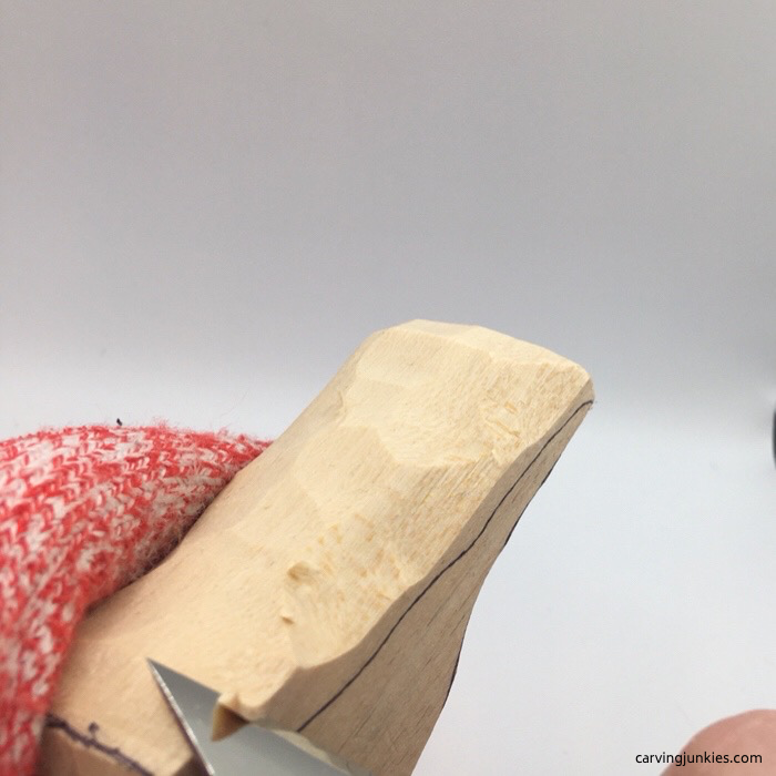 Shaping back of wood carved cardinal