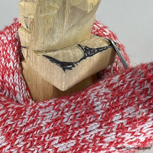 Carving big eyes on wood carved alligator