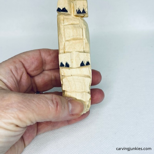 Bottom of feet is marked on wood carved alligator