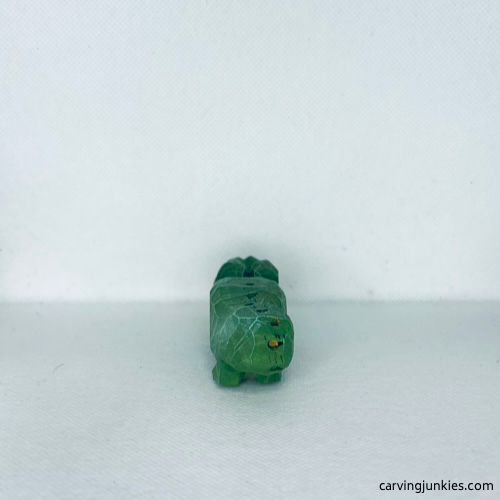 Back view of painted green wood carved alligator