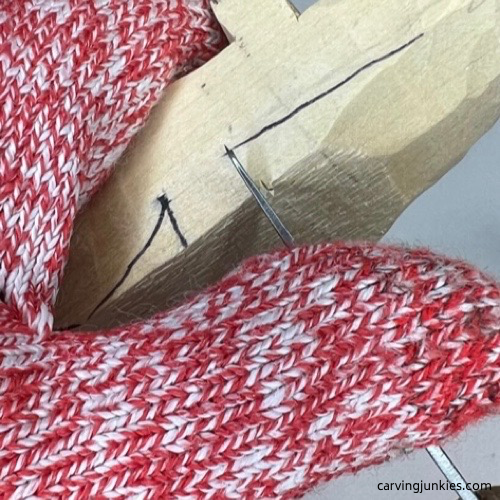 Making stop cut on wood to carve an alligator