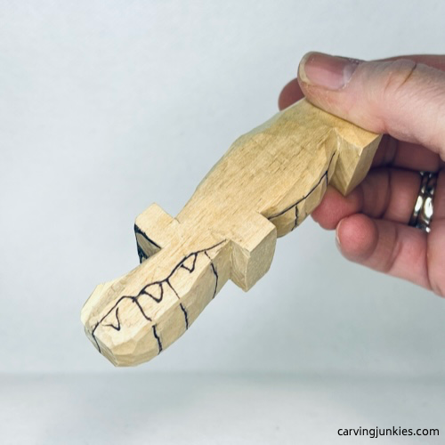 Big teeth details drawn to guide carving left side of wooden alligator