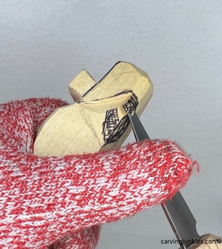 Removing wood around the tail while carving a wooden alligator