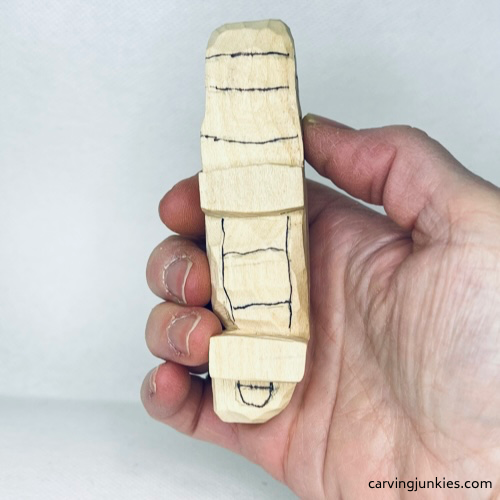 Sketched underbelly details to guide wood carving of an alligator