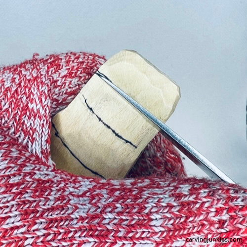 Carving the underbelly of a wood carved alligator