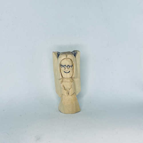 Wood is marked for removal on front of wood carved angel