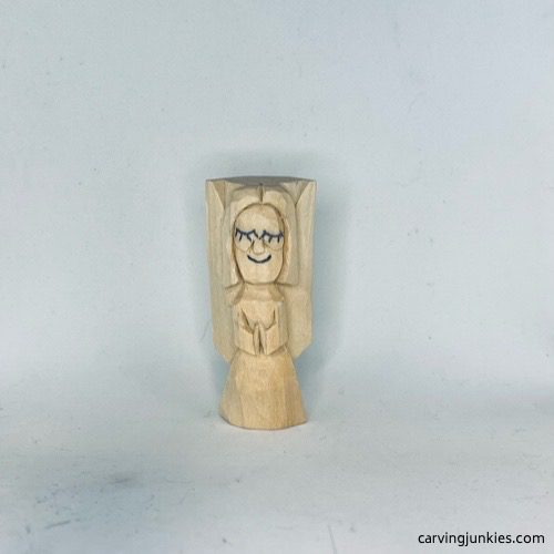 Nose is shaped on wood carved angel