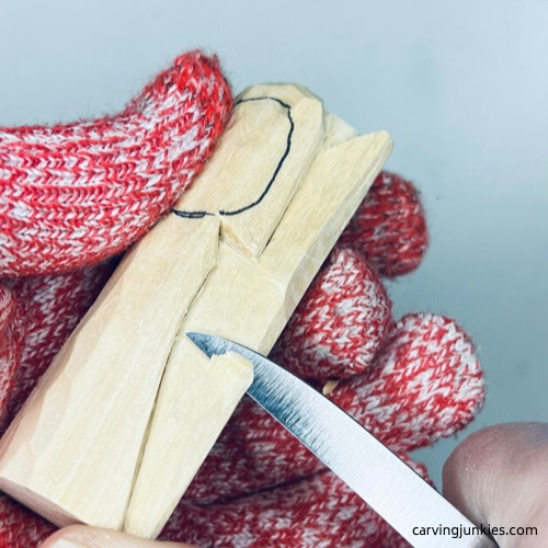 Paring down wing on wood carved angel