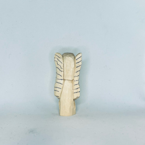 Wing lines drawn on back of wood carved angel