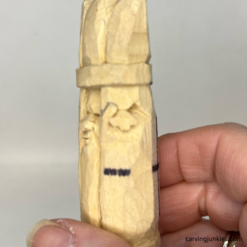Slanted eyes are carved on wood carved asparagus