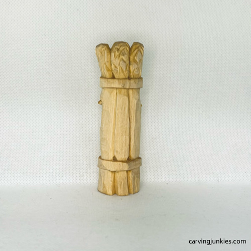 Back view of wood carved asparagus before painting