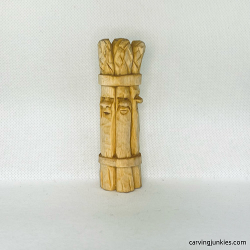Front view of wood carved asparagus before painting