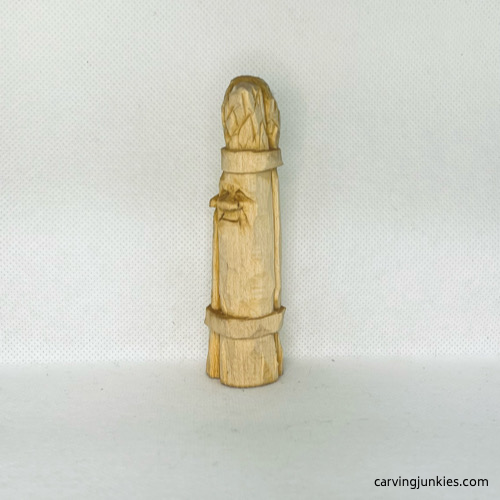 Left view of wood carved asparagus before painting