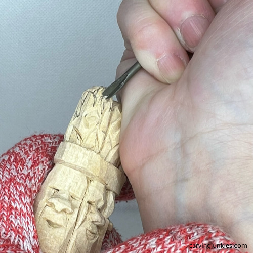 Using V-tool to carve stalk tops on wood carved asparagus