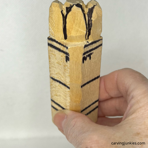 Separating tops of wood carved asparagus