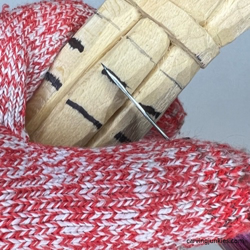 Making stop cut at eye line on wood carved asparagus