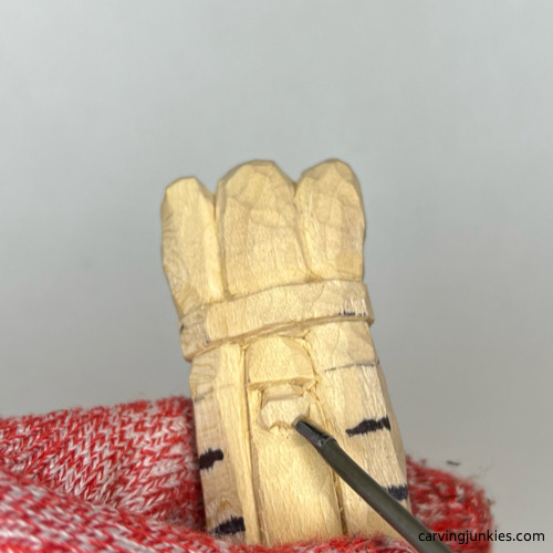Using U gouge to carve nostril on wood carved asparagus