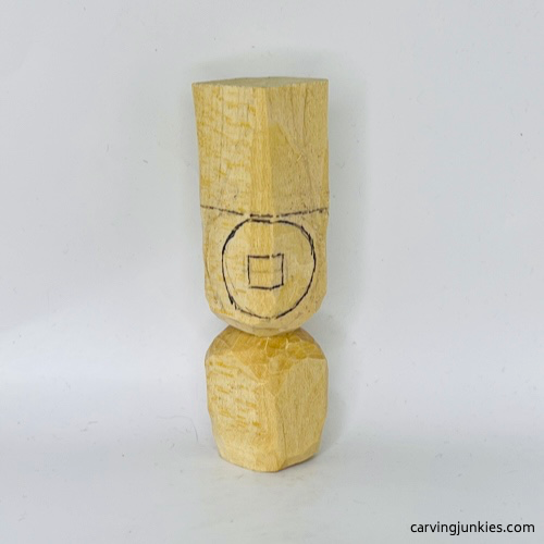 Sketched head on wood carved Christmas carolers