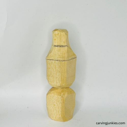 Back progress shot of wood carved Christmas caroler