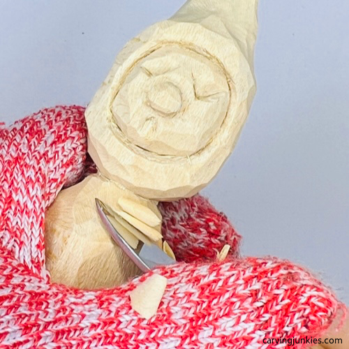 Narrowing neck on wood carved Christmas caroler