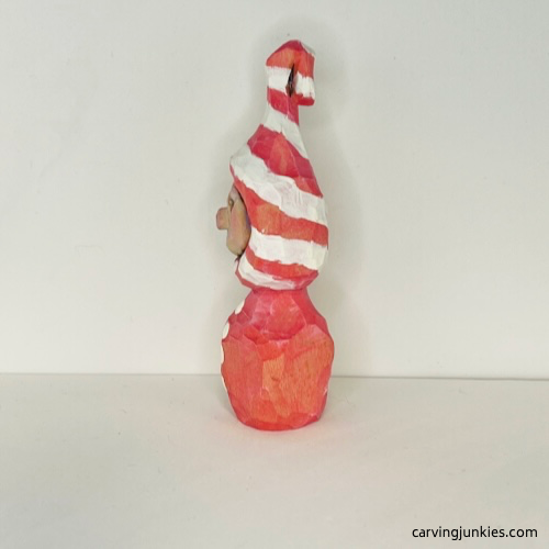 Left view of painted wood carved Christmas caroler