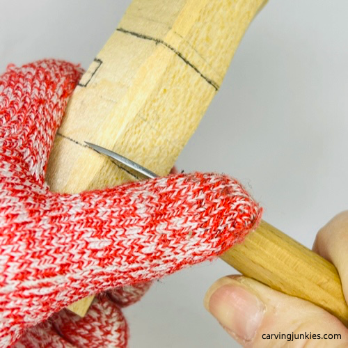 Making stop cut on wood carved Christmas caroler