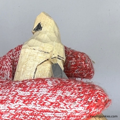 Separating face on wood carved Christmas caroler