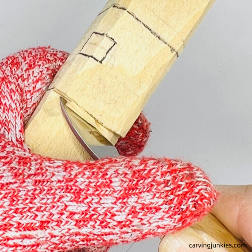 Removing wood from underneath stop cut on wood carved Christmas caroler