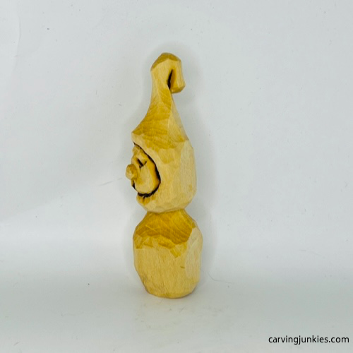 Left view of unpainted wood carved Christmas caroler