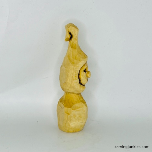 Right view of unpainted wood carved Christmas caroler