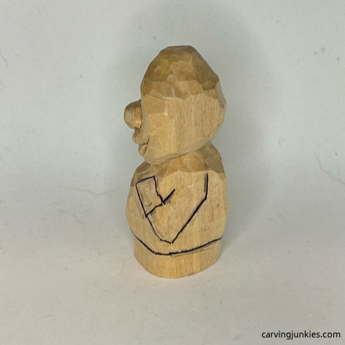 Drawn left arm on wood carved caveman Left arm is sketched on wood carved caveman