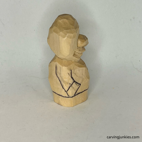 Drawn right arm on wood carved caveman Right arm is sketched on wood carved caveman