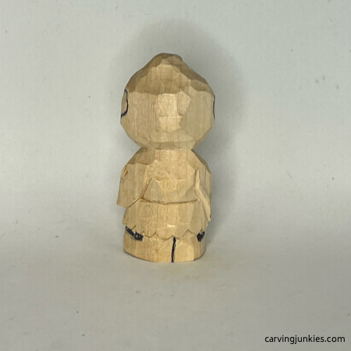 Back details drawn on wood carved caveman Back view of details sketched on wood carved caveman