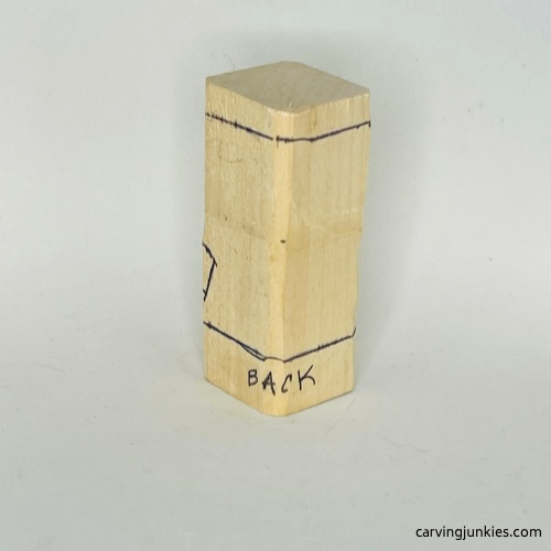 Guidelines on back of wood carved caveman Back guidelines for wood carved caveman