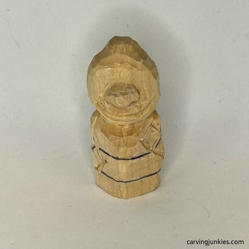 Drawn loincloth guideline on wood carved caveman Top of loincloth is sketched on wood carved caveman