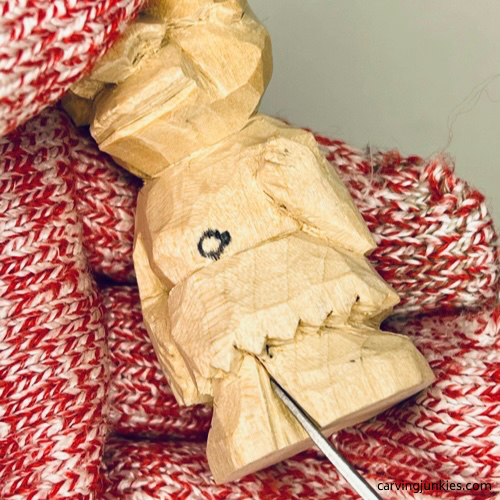 Splitting the feet on wood carved caveman Splitting the feet on wood carved caveman