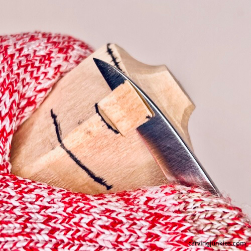 Carving from above stop cut on wood carved caveman Cutting from above on wood carved caveman