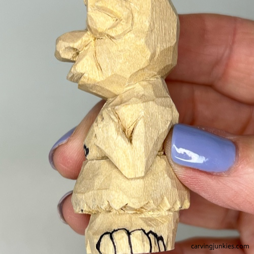 Toes are drawn on wood carved caveman Toes are sketched on wood carved caveman