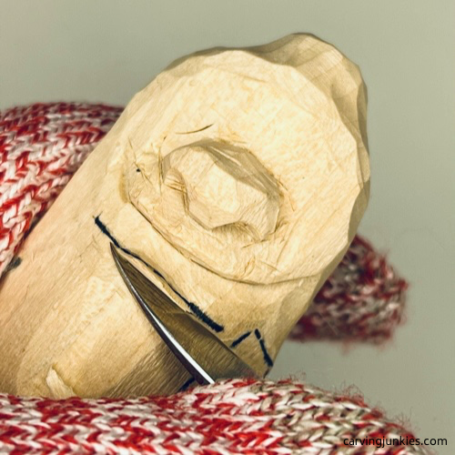 Using V-cut on neck of wood carved caveman Making a V cut on neck of caveman wood carving